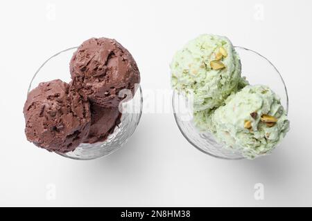 Delicious chocolate and pistachio ice creams on white background, flat lay Stock Photo