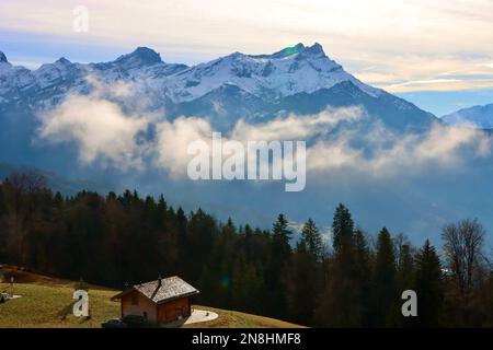 Clouds passing mountain range seen from Les Ecovets in Switzerland. Stock Photo