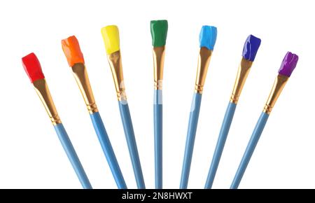 Collage of brushes with different bright paints on white background Stock Photo