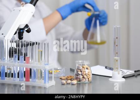 Pistachios on table and scientist proceeding quality control in laboratory Stock Photo