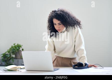 Young business woman worker working using laptop in office standing at desk. Stock Photo