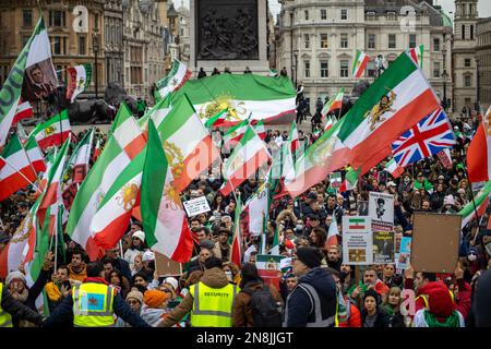 London, UK - 11 Feb 2023: As today marks the 44th anniversary of the Islamic Revolution in Iran. After more than five months of continuous protest in support of the woman, life, freedom movement, Thousands of protesters gathered in Trafalgar Sq. to denounce the Regime in Iran.  Protesters were holding banners with anti-regime symbols, such as Mahsa Amini’s picture and the Shir-o-Khorshid (Lion and Sun) flag of Iran—the flag, or its emblem, were part of Iranian national identity for centuries—which was changed after the Islamic Revolution in 1979.   Credit: Sinai Noor/Alamy Live News Stock Photo