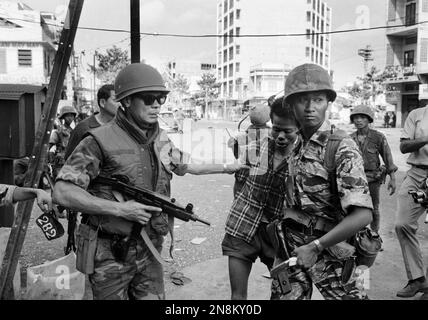 South Vietnamese forces escort suspected Viet Cong officer Nguyen Van ...