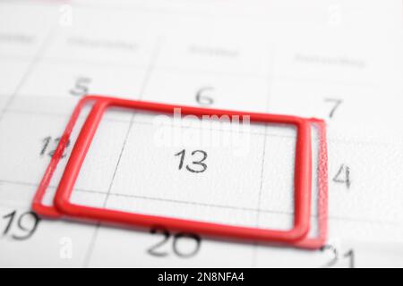 Closeup view of calendar page, focus on Friday 13. Bad luck superstition Stock Photo