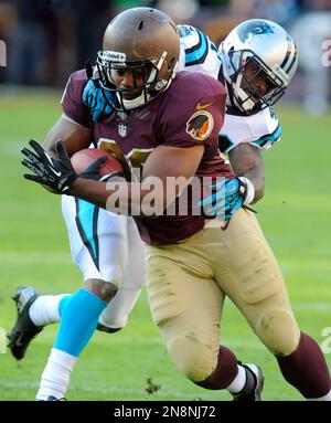 Washington Redskins Darrel Young is tackled by Minnesota Vikings' Jamarca  Sanford (33) and Chad Greenway (52) during the third quarter at FedEx Field  in Landover, Maryland on December 24, 2011. UPI/Kevin Dietsch