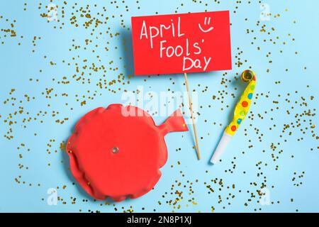 Whoopee cushion with party decor on lilac background. April Fools Day ...