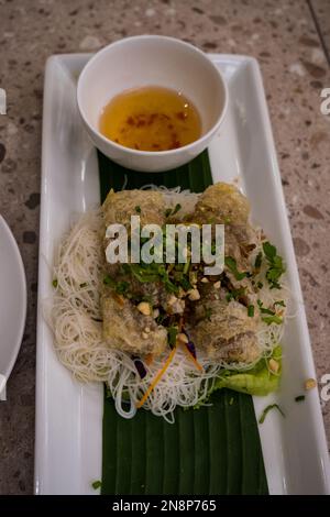 Plate Of Vietnamese Fried Spring Rolls With Vermicellu and Dipping Sauce. Close up shot. Stock Photo