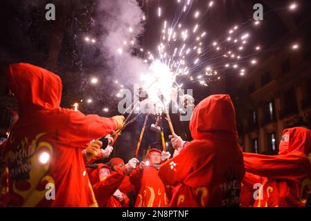 Barcelona, Spain. 11th Feb, 2023. Attendees hold burning fireworks during the event. The traditional Catalan procession of Correfocs is seen in the city center during the celebrations for Santa Eulalia festivity. Correfocs is a tradition of the Catalan folklore where people dressed as evils run in the streets with pitchforks with fireworks on them. Credit: SOPA Images Limited/Alamy Live News Stock Photo