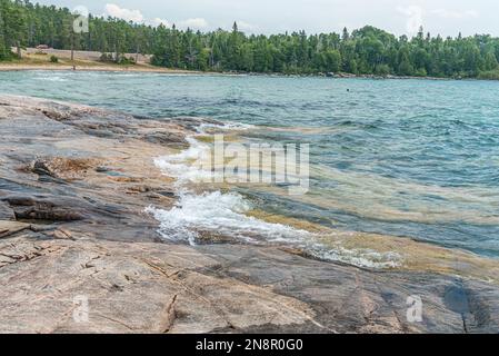 Surf at rocky promontory in Superior Lake Park. Canada Stock Photo