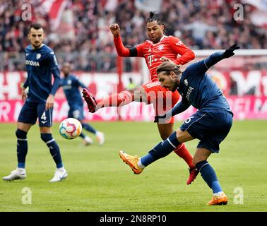 Muenchen, Germany. 11th Feb, 2023. Serge Gnabry (C) of Bayern Munich vies with Konstantinos Stafylidis (R) of Bochum during the German Bundesliga match between Bayern Munich and VfL Bochum 1848 in Munich, Germany, Feb. 11, 2023. Credit: Philippe Ruiz/Xinhua/Alamy Live News Stock Photo