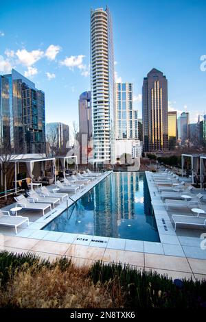 A vertical shot of residential buildings reflecting on a pool in downtown Dallas, USA Stock Photo