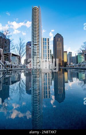 A vertical shot of residential buildings reflecting on a pool in downtown Dallas, USA Stock Photo