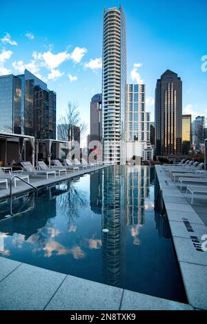 A vertical shot of residential buildings reflecting on a pool in downtown Dallas, USA Stock Photo