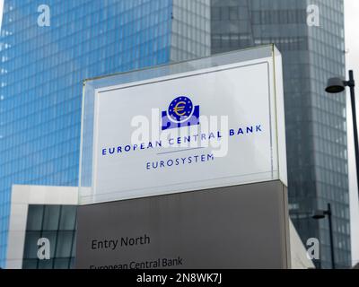Sign of the European Central Bank at the entrance in front of the skyscraper. Symbol of the ECB. Important institution in the Eurosystem for money. Stock Photo