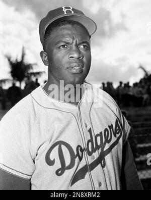 Jackie Robinson, Brooklyn Dodgers Infielder, leaps into the air as he and  Dodgers' captain Pee Wee Reese work on the execution of the double play at  the Dodgers Vero Beach, Fla., training