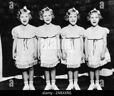 The smiling faces of the 6-year-old Morlok quadruplets as they prepared for  their debut as entertainers ina fete at Lowell, Michigan, on Aug. 23, 1936.  From left to right; Edna A., Wilma