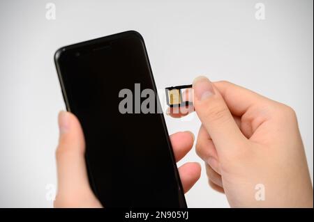 SIM card replacement in the phone. Mobile Simcard Stock Photo