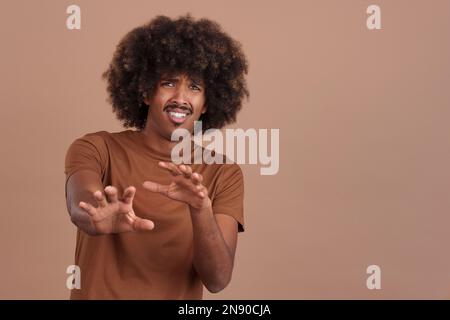 African man gesturing with the hands in fear Stock Photo