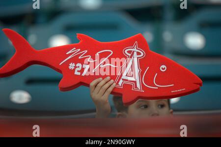 A young fan holds up a foam finger and a Pirate Parrot plush toy during the  Pittsburgh Pirates' home-opener baseball game against the Chicago Cubs on  Tuesday, April 12, 2022, in Pittsburgh. (