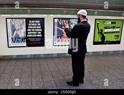 https://l450v.alamy.com/450v/2n90njg/cyrus-mcgoldrick-advocacy-director-for-council-on-american-islamic-relations-makes-a-photo-with-his-cell-phone-of-an-anti-muslim-poster-on-monday-sept-24-2012-in-new-yorks-times-square-subway-station-a-federal-court-forced-the-metropolitan-transportation-authority-to-run-the-ad-by-blogger-pamela-geller-executive-director-of-the-american-freedom-defense-initiative-saying-it-was-protected-speech-under-the-first-amendment-as-civil-rights-advocates-we-defend-pam-gellers-rights-as-a-racist-and-a-bigot-said-mcgoldrick-muslims-are-tired-of-being-targets-while-extremes-feed-their-pro-2n90njg.jpg