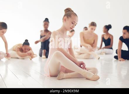 To dance is to be out of yourself. a group of young ballerinas preparing for their routine. Stock Photo