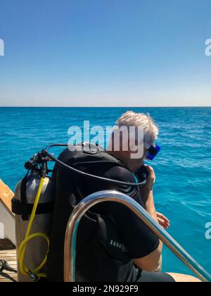 Diver getting ready to dive. Diving lesson in open water. Man with scuba will dive into deep sea. Hurghada, Egypt - October 2022 Stock Photo