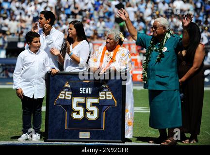 Family members of former Chargers linebacker Junior Seau attend a ceremony to retire Seau s No. 55 jersey before the Chargers face the Tennessee Titans in an NFL football game on Sunday Sept. 16 2012 ...
