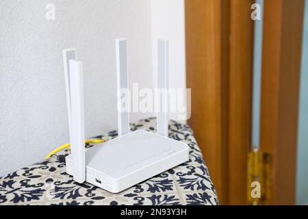 Home dual-band router with four antennas is in the apartment Stock Photo