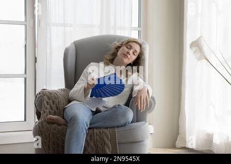 Tired relaxed beautiful young woman suffering from heat Stock Photo