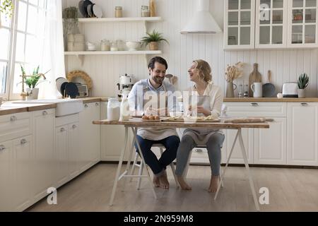 Happy married couple baking together, cooking pastry food Stock Photo