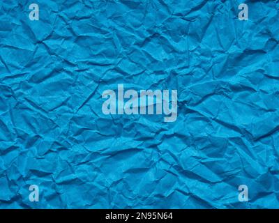 Dark matte blue crumpled paper texture. Blank page pattern for winter season Christmas festival card, new year designs decoration, background concepts Stock Photo