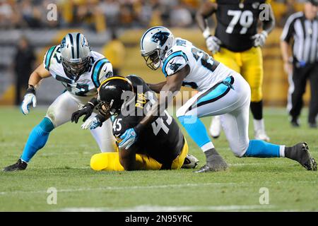 Pittsburgh Steelers' Leonard Pope (45) gets wrapped up by Carolina Panthers'  Thomas Keiser (98), Terrell McClain (97), and R.J. Stanford (25) during the  first half of their pre-season game on Thursday, August