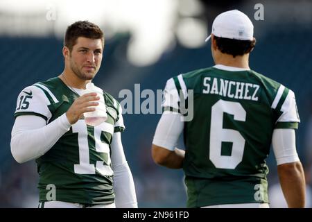 ADVANCE FOR WEEKEND EDITIONS, AUG. 25-26 - FILE - This Aug. 10, 2012 file  photo shows New York Jets quarterbacks Tim Tebow, left, and Sanchez during  warms up prior to an NFL