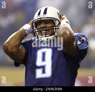 Tennessee Titans quarterback Steve McNair, top center, powers his way  through Chicago Bears' Mike Brown (30) and Shawn Wooden (22) to make a  one-yard quarterback keeper touchdown in the first quarter Friday