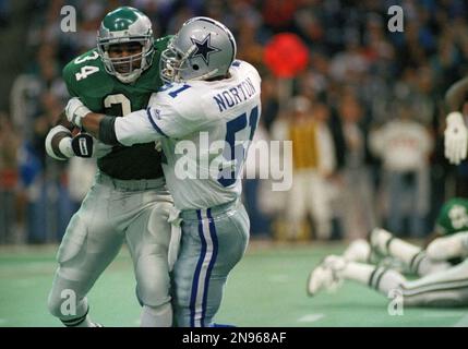 Philadelphia Eagles' running back Herschel Walker (34) is tackled by  Washington Redskins Darrell Green (28), during first quarter NFL action at  RFK Stadium, Nov. 28, 1993. Walker gained short yardage on the play. (AP  Photo/J. Scott Applewhite Stock