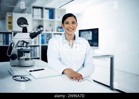 Making a difference makes me happy. Portrait of a young scientist conducting medical research in a laboratory. Stock Photo