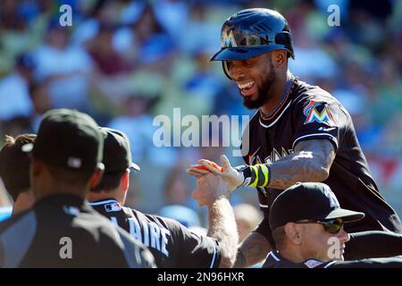 Miami Marlins Jose Reyes motions his team mates after sliding into second  base against the New York Yankees at the new Miami Marlins Ball Park in the  second exhibition game April 2