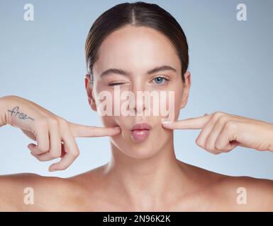 Nice plump lips. Studio portrait of an attractive young woman posing against a grey background. Stock Photo
