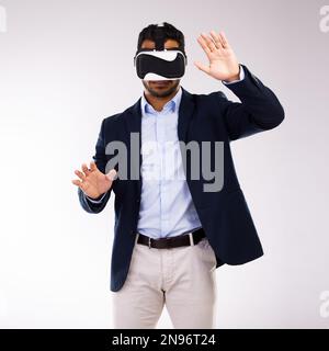 Life is a fantasy. Studio shot of a young man wearing a VR headset against a white background. Stock Photo