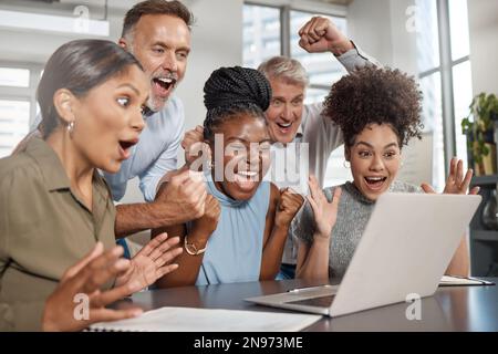 Weve got a passion for business. a group of businesspeople using a laptop at work. Stock Photo