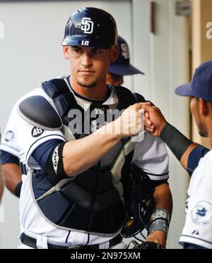 Yasmani Grandal of the San Diego Padres jokes wioth teammates