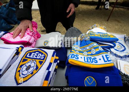 A street vendor sells Leeds United merchandise outside Elland Road Stadium ahead of the Premier League match Leeds United vs Manchester United at Elland Road, Leeds, United Kingdom, 12th February 2023  (Photo by James Heaton/News Images) Stock Photo