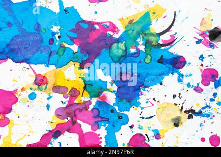 Spilled printer ink. Abstract colorful splatter on watercolor textured background.  Top view. Stock Photo