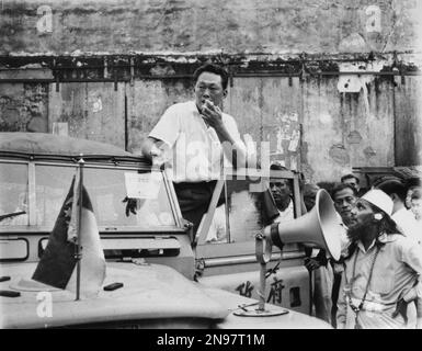 Singapore Prime Minister Lee Kuan Yew stands on the running