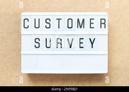 Lightbox with word customer survey on wood background Stock Photo