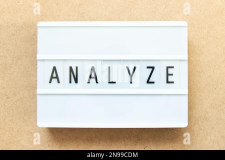 Lightbox with word analyze on wood background Stock Photo