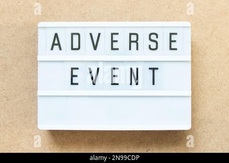 Lightbox with word adverse event on wood background Stock Photo