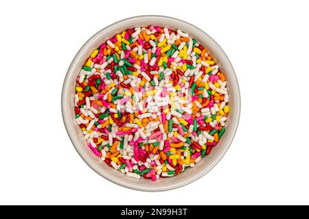 Rainbow sprinkles in white ceramic bowl on white background with clipping path Stock Photo