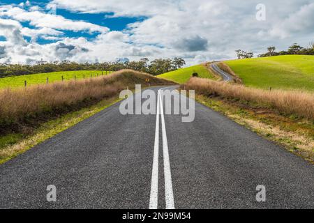 Winding road through Adelaide Hills farms during winter season, South Australia Stock Photo