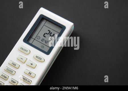 Air conditioner remote on black background. Close up air conditioner 24 degrees celsius Stock Photo